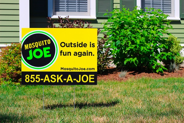 Mosquito Joe Yellow Yard Sign placed in front of a home